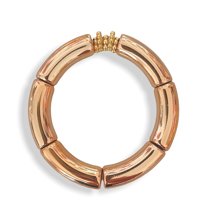 Circle bracelet made up of cylindrical rose gold pieces with gold beaded accent piece.